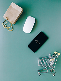 Flatlay shopping cart, phone, mouse and bag